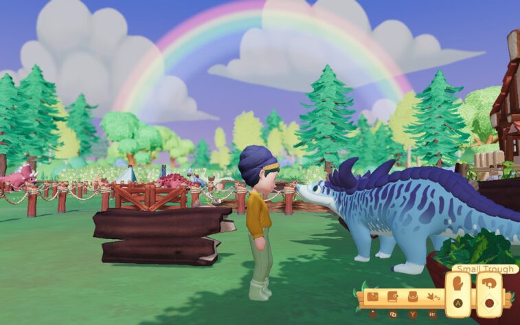 A character stands in the center of the image, looking at a blue dinosaur who looks back. They stand on a farm, with fencing containing other dinosaurs in the background. Trees crowd the horizon, and a rainbow arches across the sky.