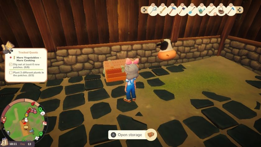 YvoCaro in the shed in front of the chest, and a cow's head sticks through the stone wall