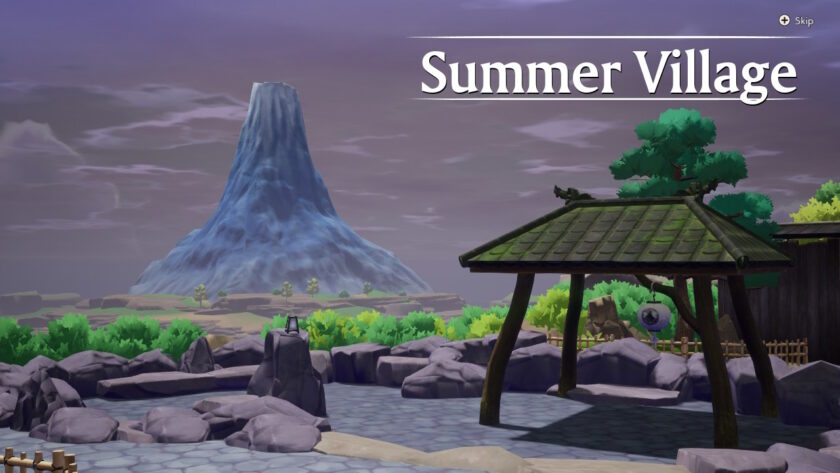 A peaceful scenic view in Rune Factory: Guardians of Azuma labeled “Summer Village,” featuring a traditional Japanese-style structure on the right, rocky terrain in the foreground, and a distinct mountain rising in the distance under a cloudy sky. Lush greenery surrounds the area. Published on: LadiesGamers