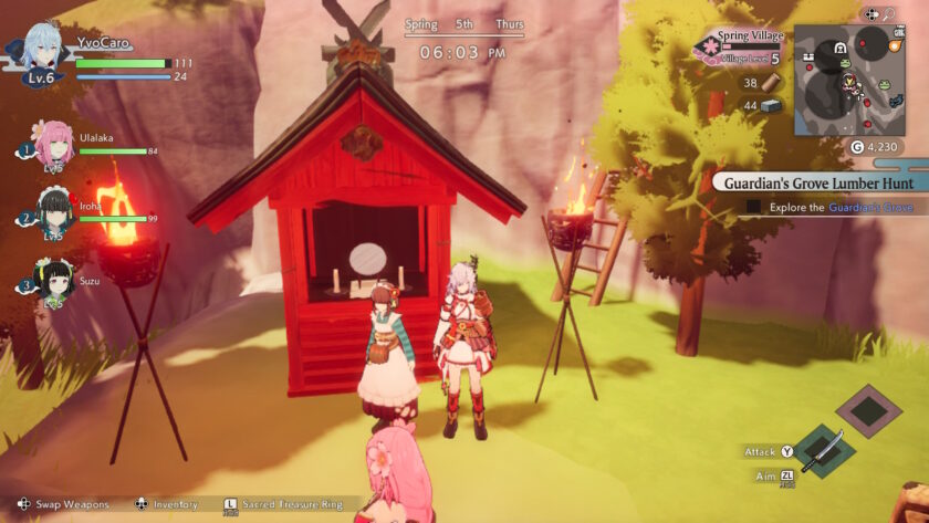 The player Rune Factory: Guardians of Azuma character stands in front of a small red shrine with another villager, flanked by burning torches. The game HUD shows the time, date, and village level, with a quest objective titled “Guardian's Grove Lumber Hunt.” Party member portraits are displayed on the left. Published on: LadiesGamers