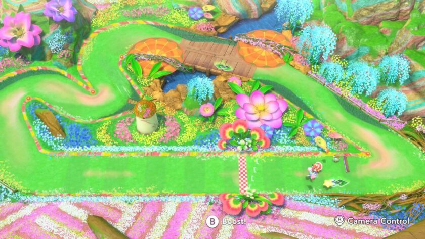 Bird's-eye view of a mini course which is colourful and bright with flowers and a windmill. Published on LadiesGamers