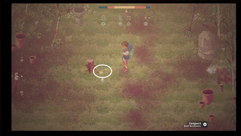 The lost half of the secateurs, near the tree stump.